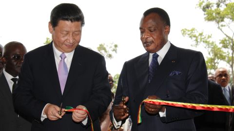 China's new President Xi Jinping (L) and Congo's Denis Sassou Nguesso President cut the ribbon on March 30, 2013, during Xi's first foreign trip.