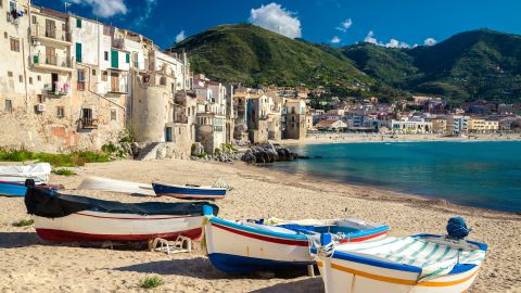 Wooden fishing boats line the beach of Cefalu, Sicily.