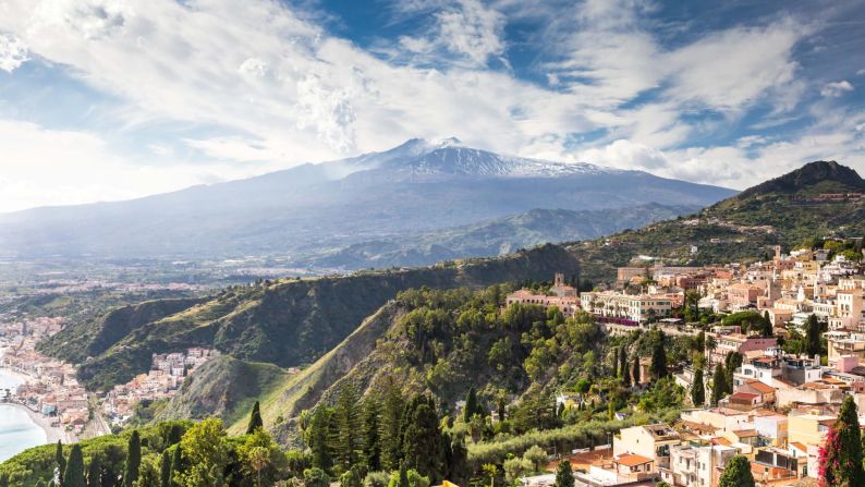 <strong>September in Sicily:</strong> Take in a scenic view of Mount Etna from Taormina. If the volcano is on good behavior, you can hike it.