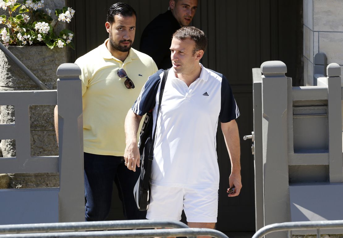 French President Emmanuel Macron leaves his house dressed for tennis with his then-deputy chief of staff Alexandre Benalla in June 2017.