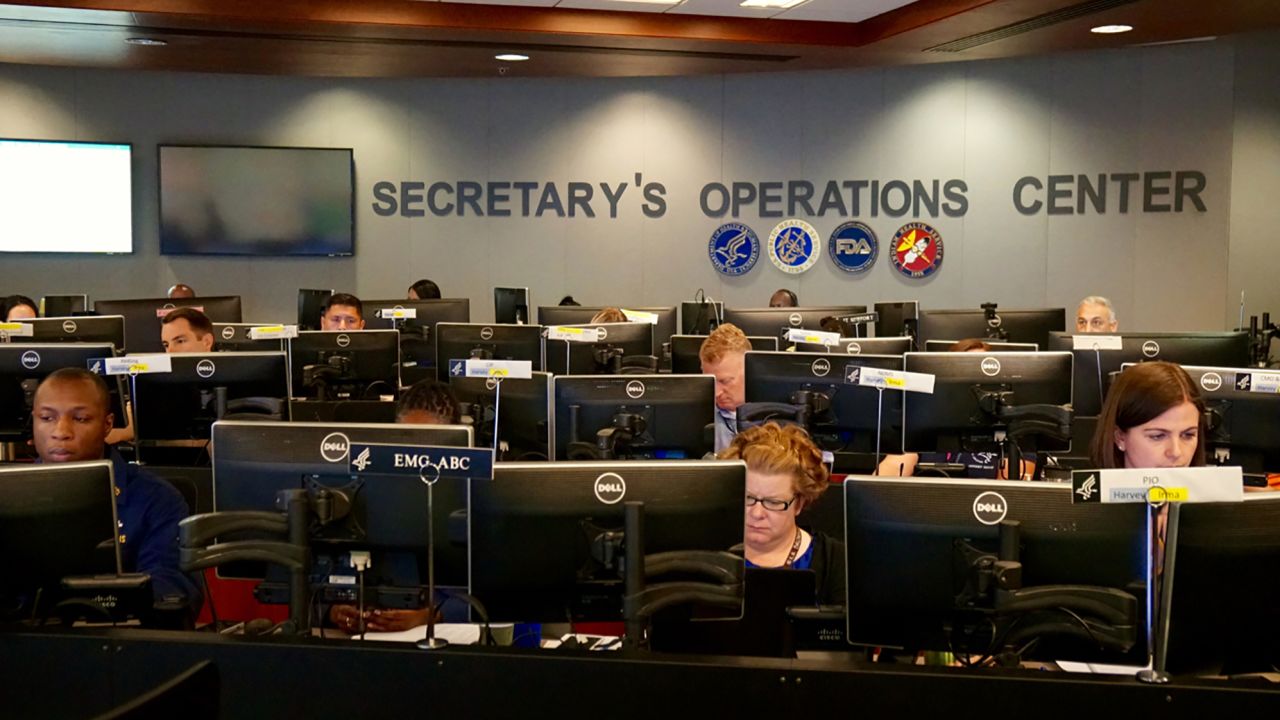 HHS staffers work to help reunite separated families at operations center in Washington.