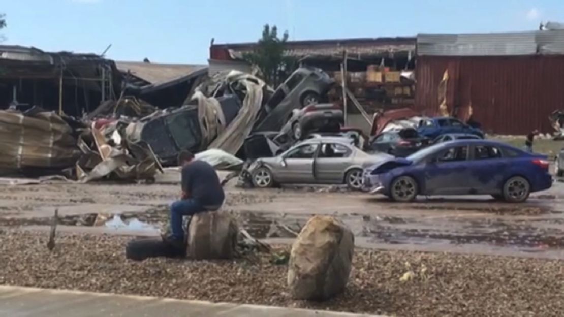 iowa tornado damage man sitting on rock