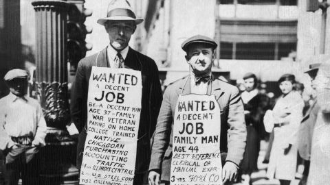 Two men advertising their willingness to find employment - 'Wanted, a decent job' - in Chicago during the Great Depression. Chicago, Illinois, in 1934. 