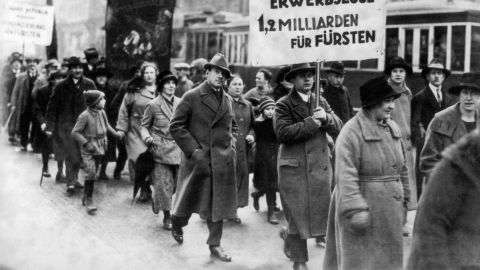 Male and female protesters during a demonstration by unemployed people in Berlin, Germany, in 1930. 