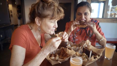 Deb Paquette and Maneet Chauhan enjoy food from The Grilled Cheeserie food truck in Nashville.