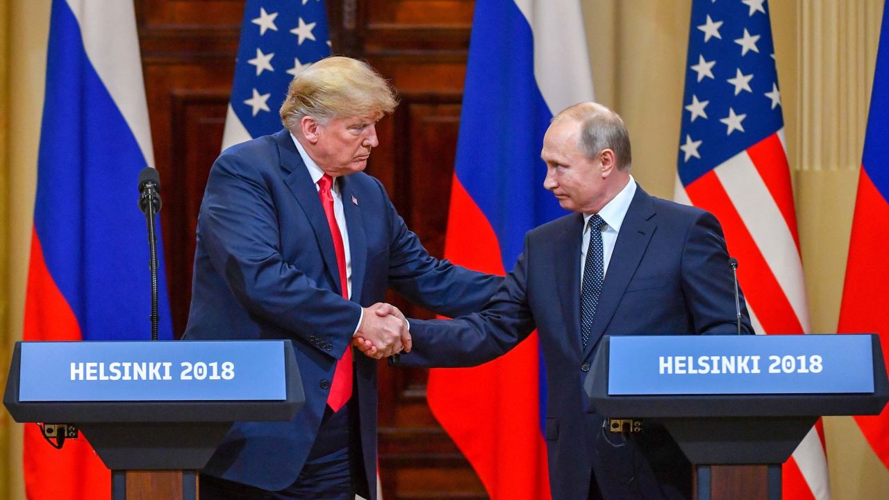 Donald Trump and Vladimir Putin shake hands before a press conference in Helsinki.