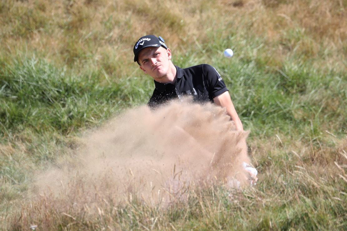 Ash Turner of England hits a bunker shot during the first round of the Open Championship in Scotland.
