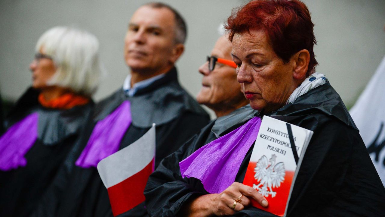 A woman dressed as a Supreme Court judge holds a copy of the Polish constitution during a protest Thursday.