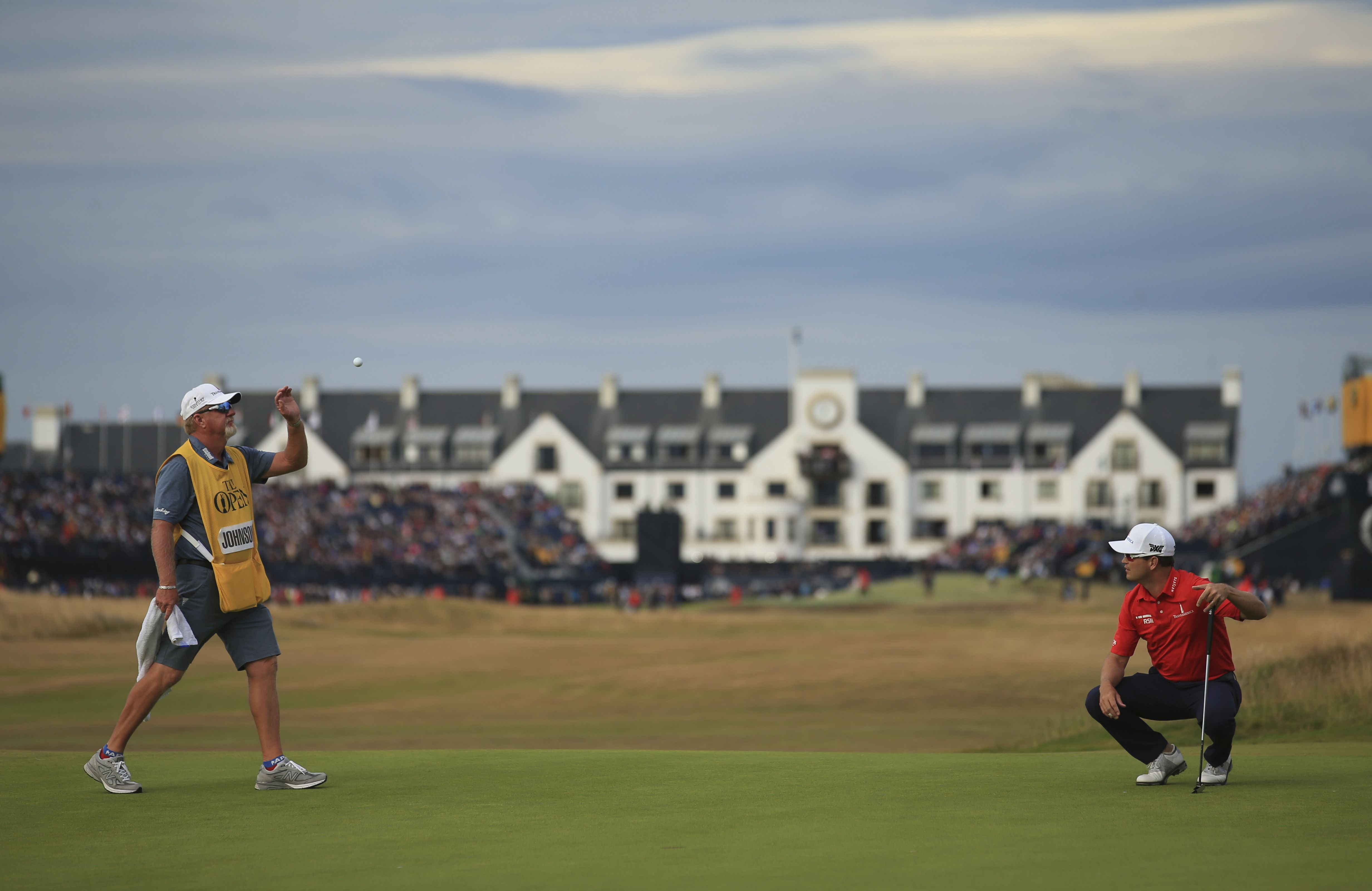 Zach Johnson throws a ball to his caddie during the third round on Saturday.