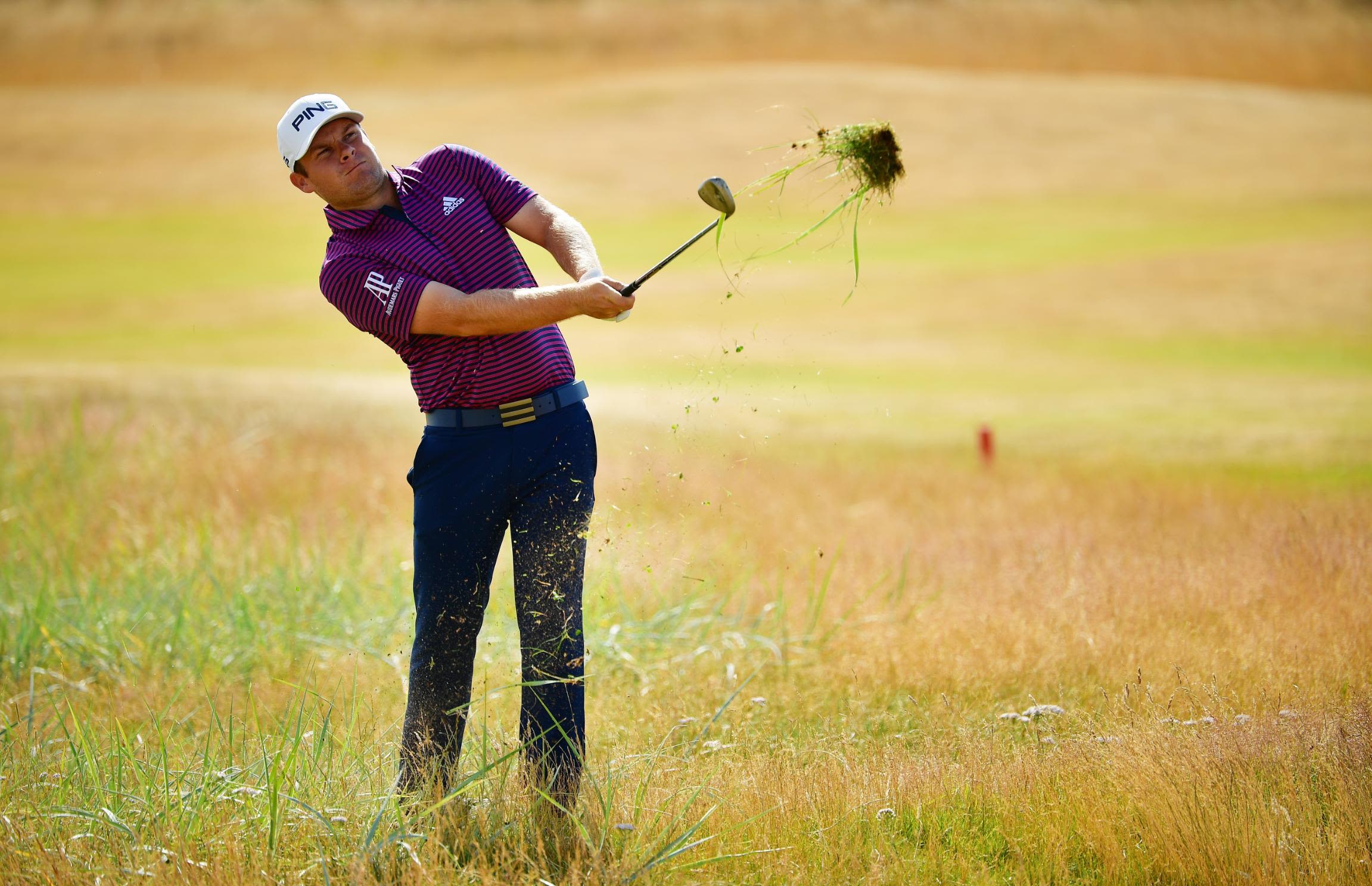 Tyrrell Hatton plays a shot from the rough on Sunday.