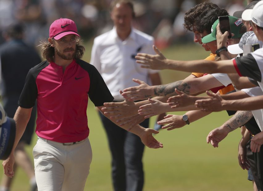 Tommy Fleetwood greets fans as he walks to the second hole on Sunday.