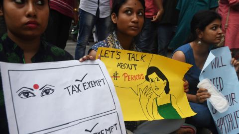 Indian students hold posters and sanitary pads during a protest over tax in Kolkata in June 2017. 