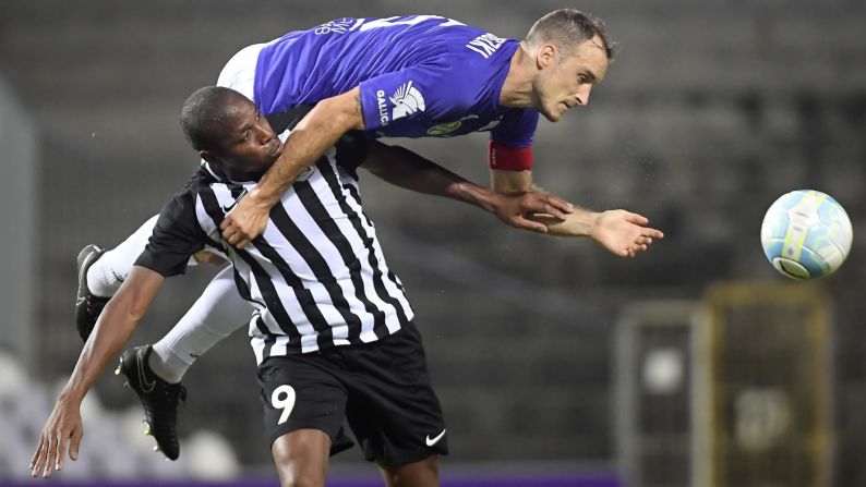 Robert Litauszki, who plays for Hungarian club Ujpest, goes over Neftci's Bagaliy Dabo during a Europa League match in Budapest, Hungary, on Thursday, July 19.