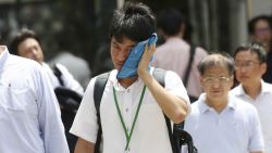 A man wipes the sweat from his face in the scorching heat at a business district in Tokyo, Monday, July 23, 2018. Searing hot temperatures are forecast for wide swaths of Japan and South Korea in a long-running heat wave. The mercury is expected to reach 39 degrees Celsius (102 degrees Fahrenheit) on Monday in the city of Nagoya in central Japan and reach 37 in Tokyo. Deaths have been reported almost every day. (AP Photo/Koji Sasahara)