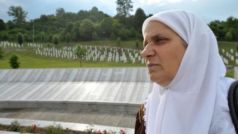 Hatidza Mehmedovic stands in the Potocari memorial cemetery near Srebrenica on June 30, 2010. 