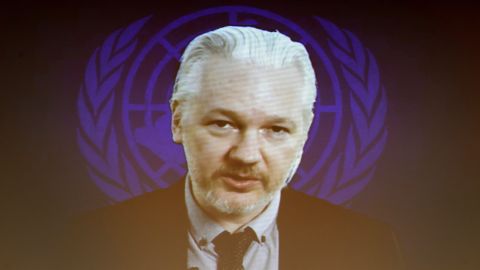 Assange is seen on a video screen in March 2015, during an event on the sideline of a United Nations Human Rights Council session.