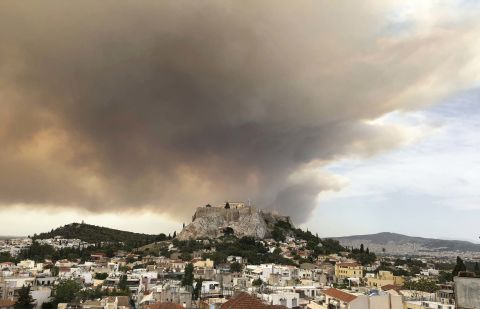 Smoke rises over Athens' ancient Acropolis hill on July 23.