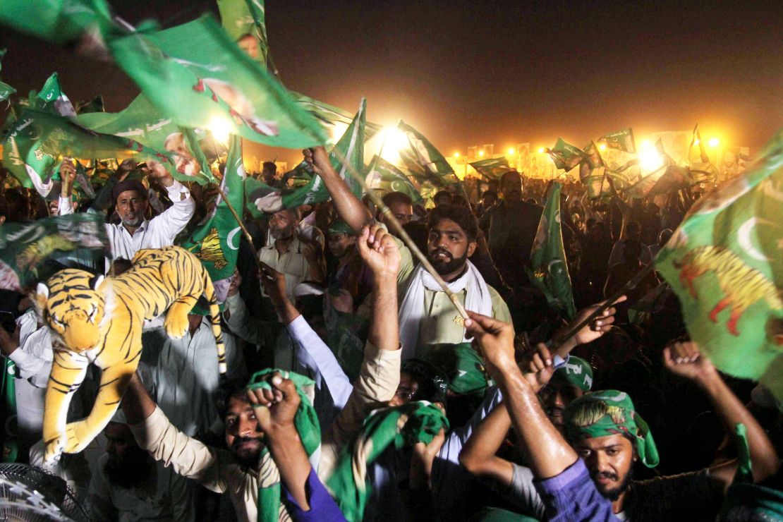 Supporters of Shahbaz Sharif, the younger brother of ousted Pakistani Prime Minister Nawaz Sharif and head of Pakistan Muslim League-Nawaz (PML-N), chant slogans and wave flags during a campaign meeting ahead of the general election in Multan on July 22, 2018.