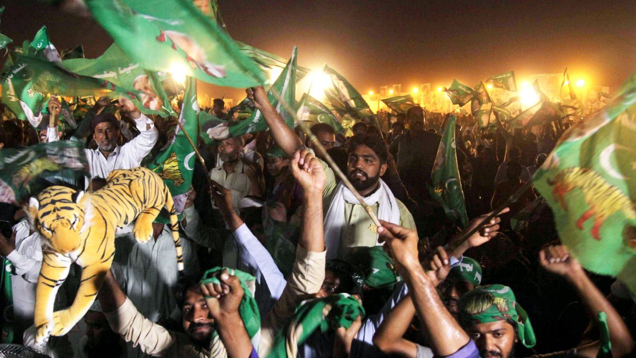Supporters of Shahbaz Sharif, the younger brother of ousted Pakistani Prime Minister Nawaz Sharif and head of Pakistan Muslim League-Nawaz (PML-N), chant slogans and wave flags during a campaign meeting ahead of the general election in Multan on July 22, 2018.