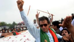 Pakistani cricketer-turned-politician Imran Khan gestures as he leads a protest march to Islamabad against the country's Pakistan Muslim League-Nawaz-led government in Wazirabad in eastern Punjab province on August 15, 2014. Clashes broke out on August 15, 2014 as protesters led in convoys by cricketer-turned-politician Imran Khan and a populist cleric advanced on the Pakistani capital to try to topple the government they say was elected by fraud. Khan and preacher Tahir-ul-Qadri say the May 2013 general election that brought Prime Minister Nawaz Sharif to power in a landslide was rigged, and are demanding he resign and hold new polls. AFP PHOTO/Asif HASSAN        (Photo credit should read ASIF HASSAN/AFP/Getty Images)