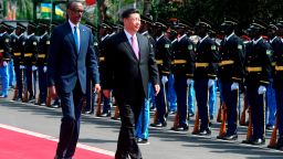 Chinese President Xi Jinping (C) inspects a guard of honor, accompanied by Rwandan President Paul Kagame (L), upon his arrival at the Urugwiru State house in Kigali on July 23, 2018 during a two-day state visit in Rwanda. 