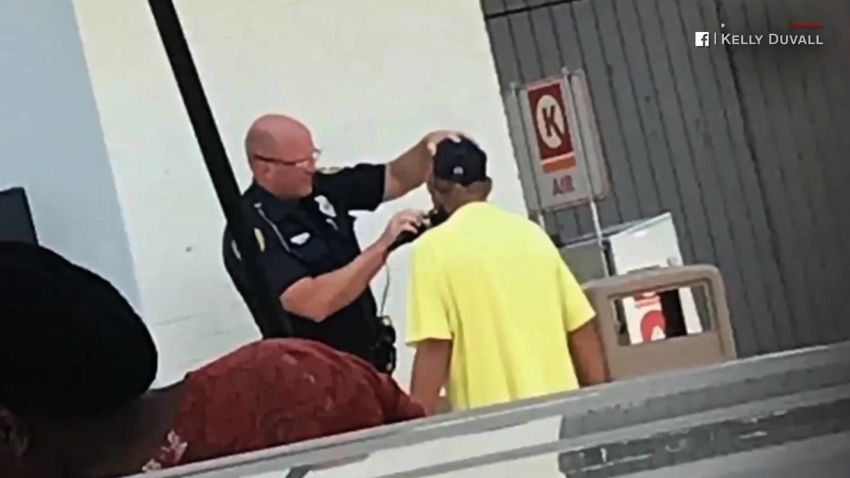 Officer helps man shave