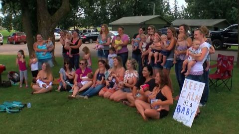 Moms took part in a protest outside a Minnesota public pool after two women were told to cover up while breastfeeding.