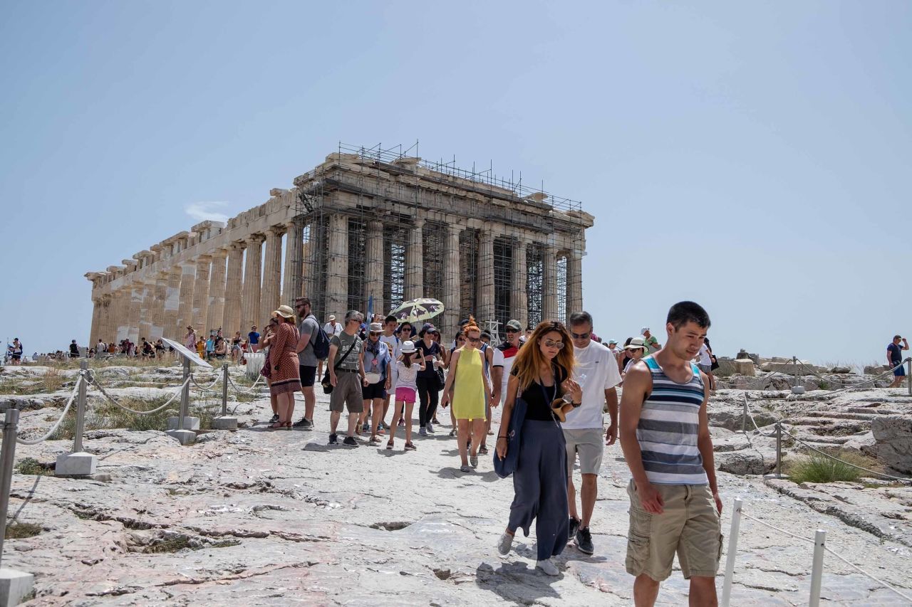 Tourists leave the Acropolis after authorities decided to close the archaeological site as a precaution.