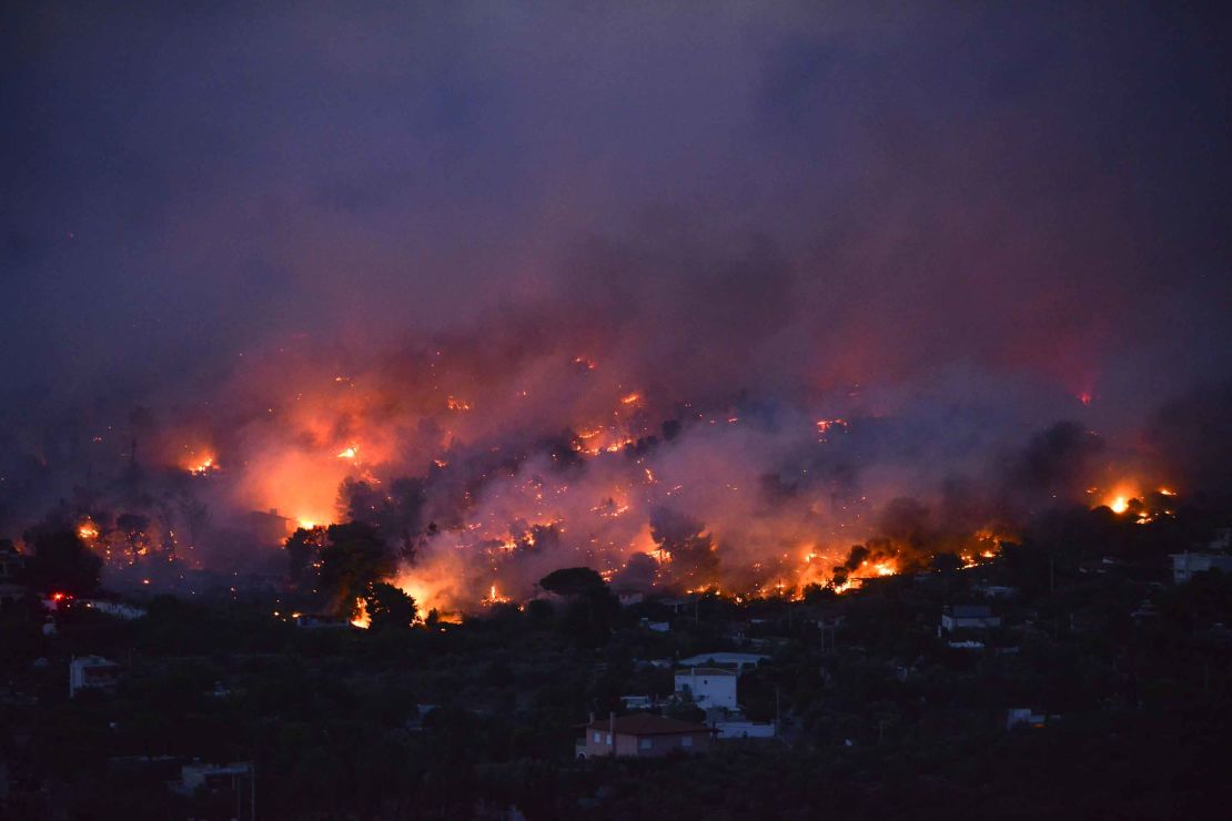 Flames rise above the  town of Rafina, near Athens. 