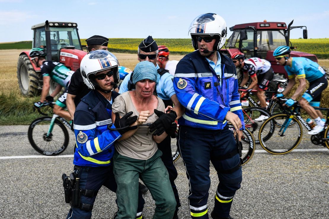 Gendarmes detain a protesting farmer.