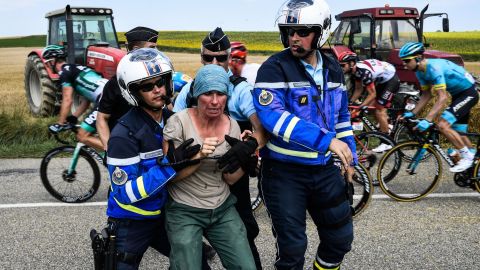 Gendarmes detain a protesting farmer.