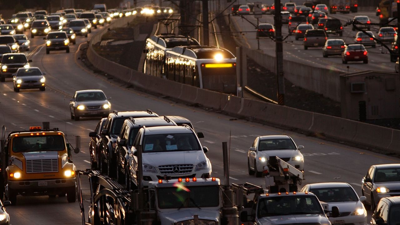 PASADENA, CA - DECEMBER 1:  Morning commuters travel by car and train along the 210 freeway between Los Angeles and cities to the east on December 1, 2009 near Pasadena, California. President Barack Obama will attend the international climate negotiations in Copenhagen next week with a vow to reduce US greenhouse gas emissions to about 17 percent below 2005 levels by 2020, and 83 percent by 2050. Meanwhile, California, which has some of the toughest clean air laws after decades of fighting some of the worst smog in the nation, is in the final phase of building a cap-and-trade market to provide incentives to reduce greenhouse emissions.  More than 60 world leaders are expected to take part in the climate negotiations in Copenhagen.   (Photo by David McNew/Getty Images)