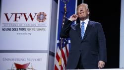 President Donald Trump puts his hand to his ear as music plays during his arrival to speak to the national convention of the Veterans of Foreign Wars, Tuesday, July 24, 2018, in Kansas City, Mo. (AP Photo/Evan Vucci)