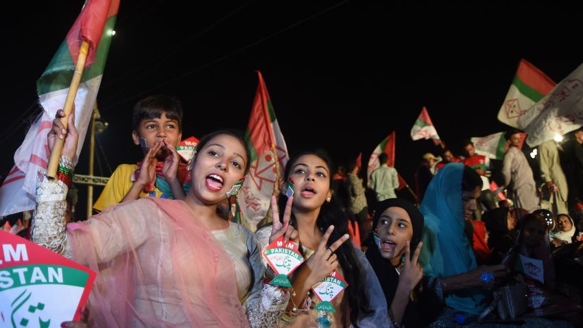 Supporters of Pakistani political Muttahida Qaumi Movement (MQM) party hold party flags as they attend a campaign meeting ahead of the general election in Karachi on July 23, 2018. - Pakistan will hold the general election on July 25, 2018. (Photo by ASIF HASSAN / AFP)        (Photo credit should read ASIF HASSAN/AFP/Getty Images)