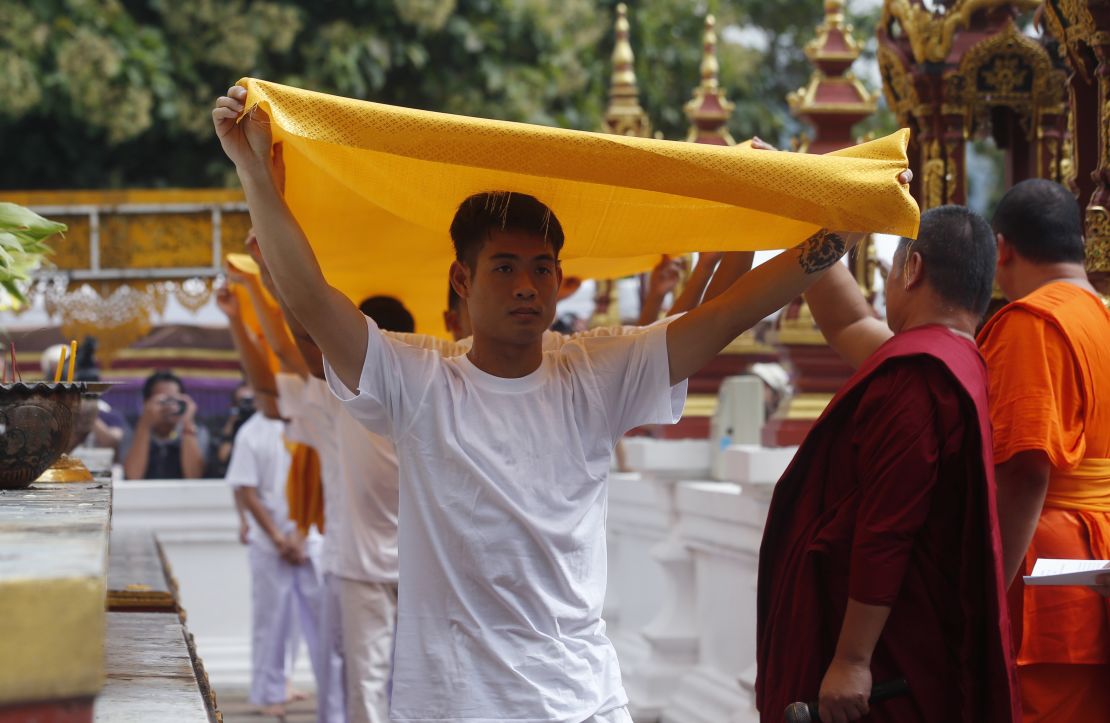 Soccer coach Ekkapol Chantawong, front, and members of the rescued soccer team attend a Buddhist ceremony on July 24.