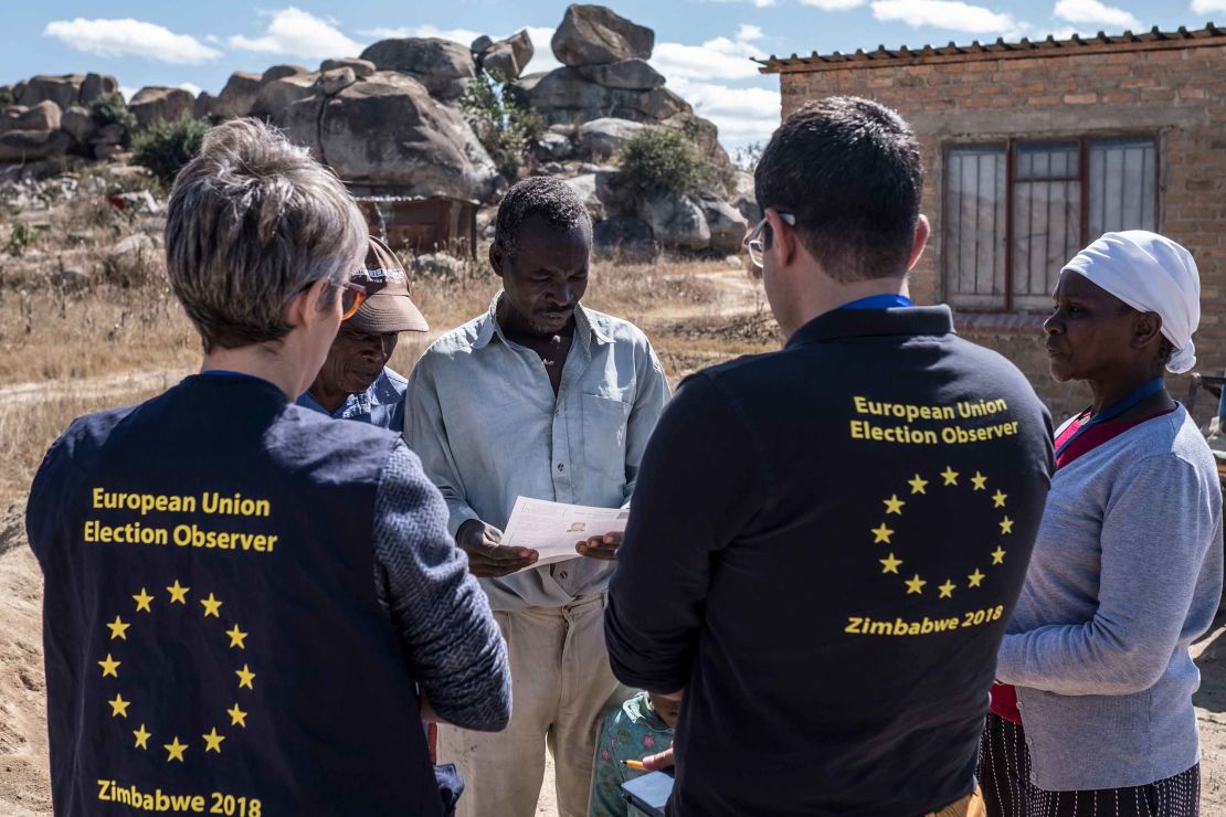 Members of a European Union election observation team speak to voters in Nyatsime, on July 24, 2018. 