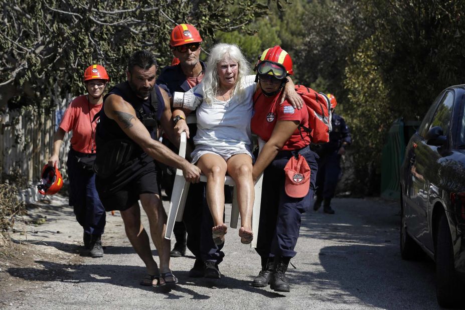 An injured woman is carried by a rescue crew in Mati on Wednesday, July 25.
