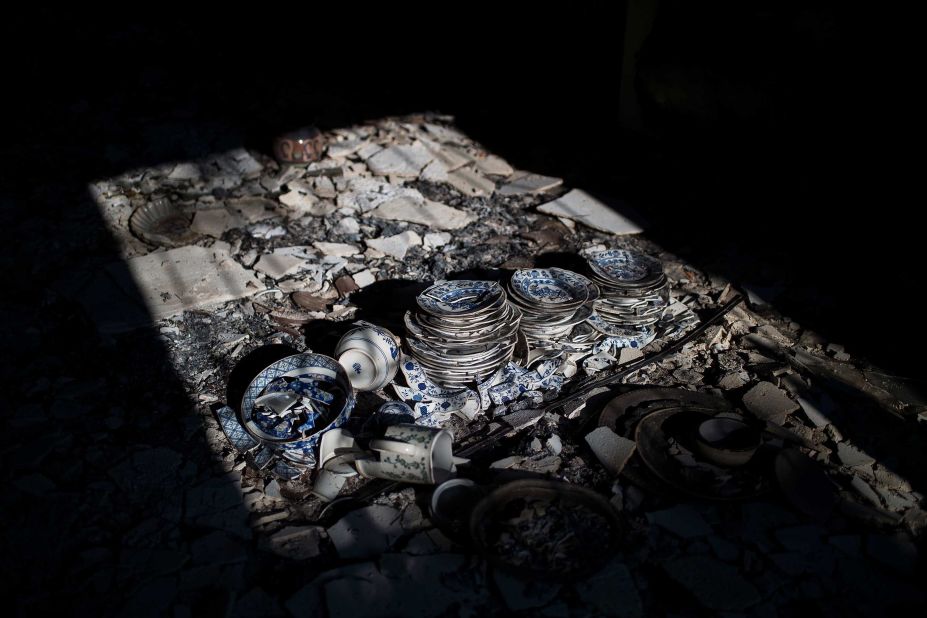 Dinnerware destroyed by the fire is seen inside a house in the village of Neos Voutzas on July 25.