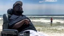 David Thomas, 36, visits the beach for the first time. This trip was his second time leaving his home county of Jefferson County, Alabama. He used a special motorized beach wheelchair to have a beach day in Panama City Beach, Florida.