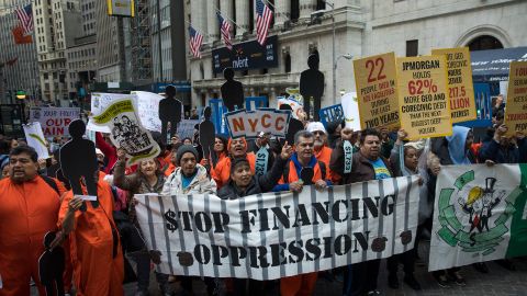 Protesters called on Wall Street to stop bankrolling private prisons at a May Day march in Manhattan. 