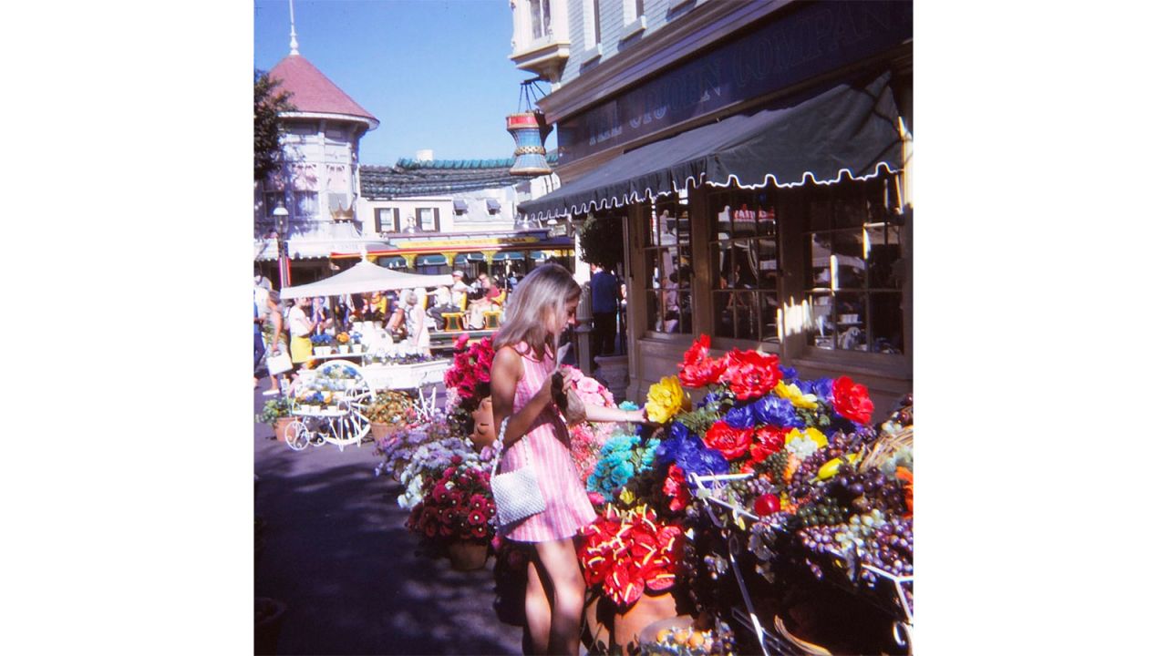 Judy pictured looking at paper flowers in the Disneyland.