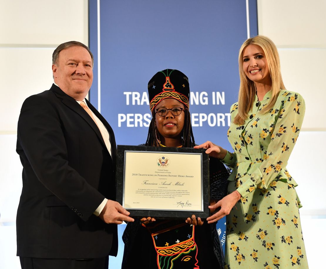 Secretary of State Mike Pompeo and Ivanka Trump present Awah with her 'TIP Report Hero' certificate.