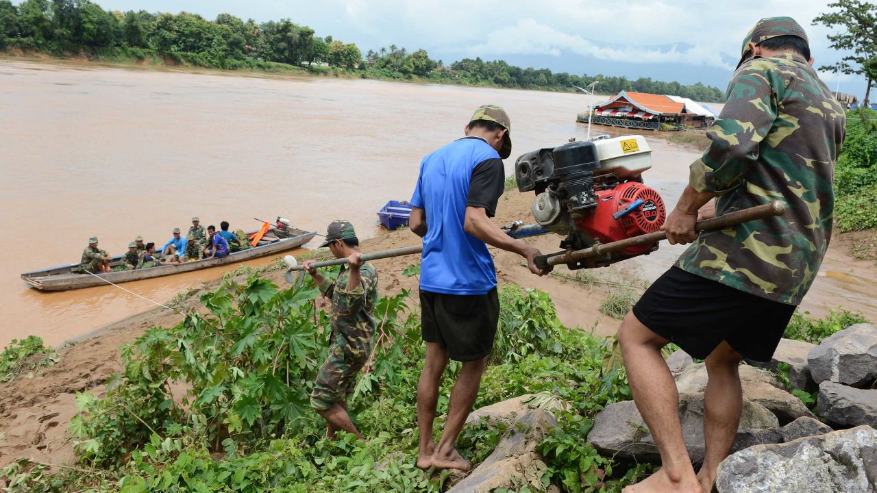 Laotian soldiers carry rescue equipment Wednesday in Attapeu province.
