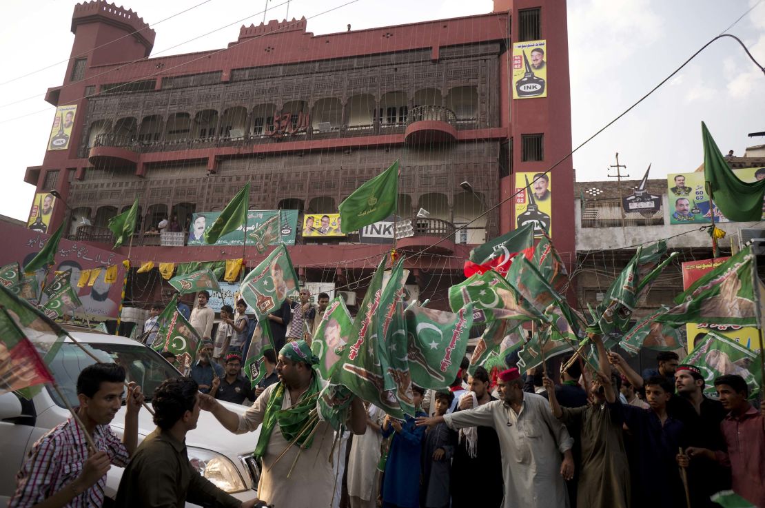 People gather outside an election office of a candidate Wednesday as polls closed in Rawalpindi.