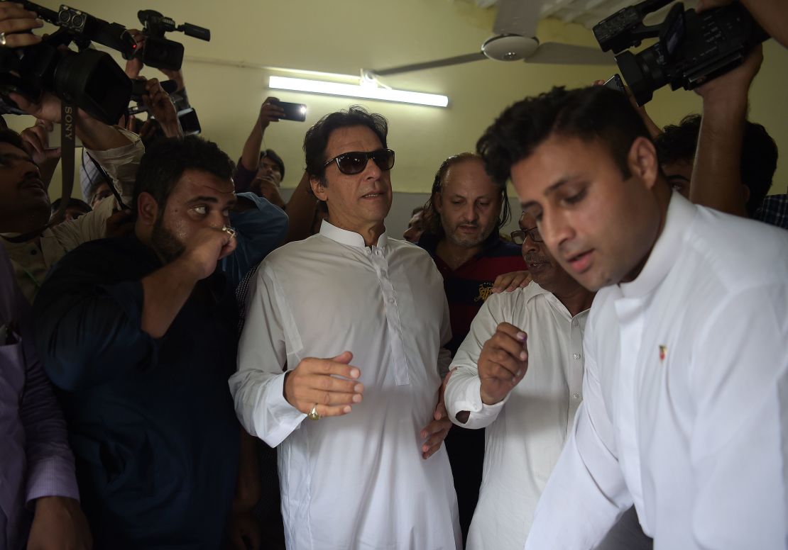 Cricket star-turned-politician Imran Khan arrives at an Islamabad polling station to vote Wednesday.