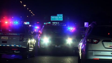 Police cars are parked on I-10 near Phoenix early Friday after one state trooper was killed and other was injured in a shooting.