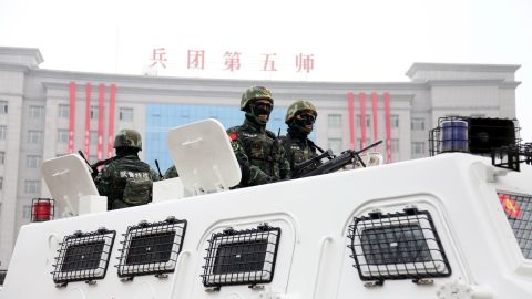 Soldiers and paramilitary police patrol during a pep rally for an anti-terrorism and maintaining stability rally in Xinjiang in March 2017. 