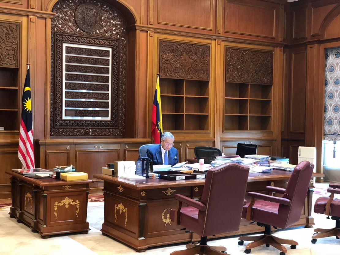 Mahathir pictured behind the same desk as during his previous premiership.