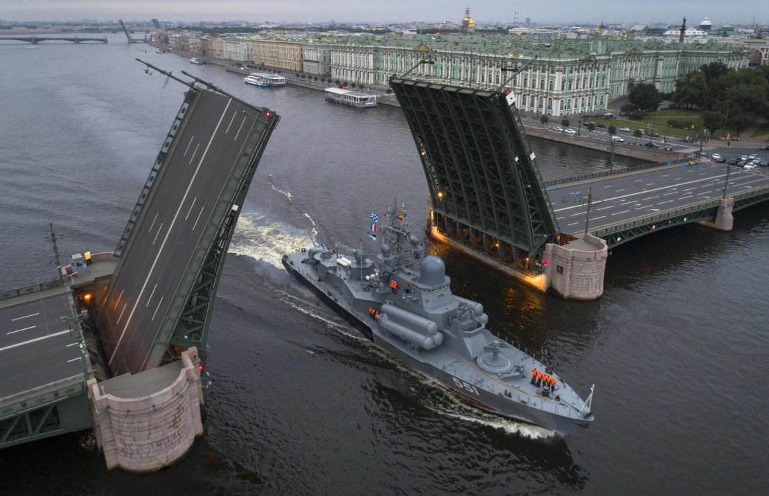A Russian warship sails past the Dvortsovy drawbridge rising above the Neva River during rehearsals for the Navy Day parade in St. Petersburg.