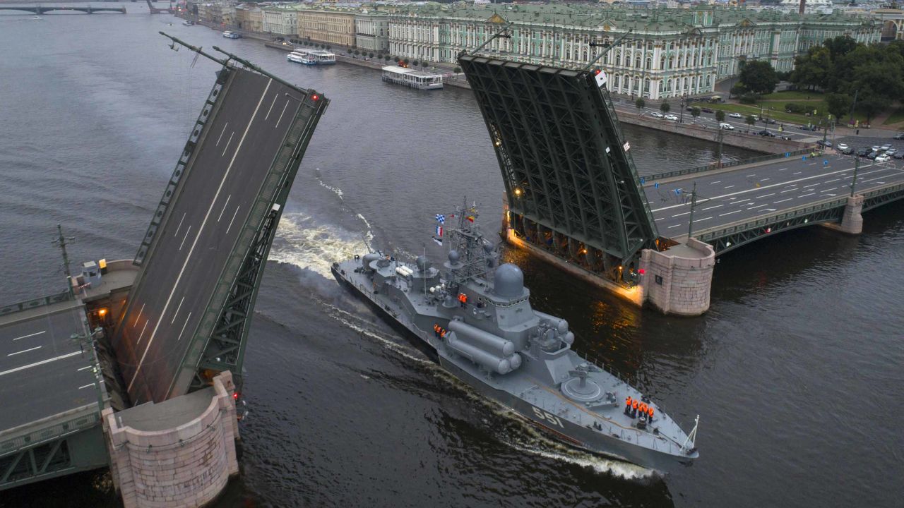 A Russian warship sails past the Dvortsovy drawbridge rising above the Neva River during rehearsals for the Navy Day parade in St. Petersburg.